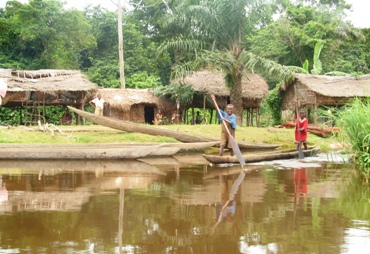 Pictured is a village along the Congo River near Lisala.  The flat-bottomed boats customarily used are called pirogues.  Photographer unknown.